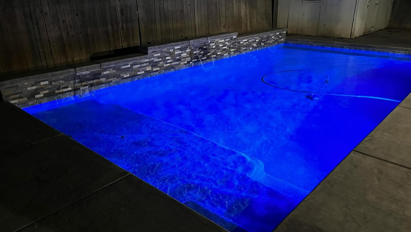 Glass mosaic waterline tile detail on a custom California pool with LED lighting